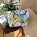 Artistic oil painting floral canvas cosmetic bag on a wooden table in a warm home setting - Monet Garden Blue Yellow