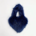 Detail showing the soft texture of a dark blue faux fur heart-shaped shell handbag - Small / Navy Blue