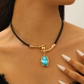 Detail of vintage choker featuring gold metal branch accents and turquoise pendant on black leather - Gold Branch Turquoise Pendant Leather Choker (1075)