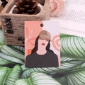 Illustrated earring display card featuring a stylish woman with hat in orange and black - Impression Girl Style One