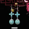 Ethnic vintage turquoise drop earrings with silver flower detail and a long tassel design - 8-Cross Round Bead