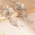 Macro shot of silver woven flower petals with central rhinestone on long tassel earrings - Flower Petal Tassel Long Style / Silver