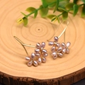 Handmade gold flower hook earrings with purple pearls and zircons on a rustic wood base - Purple Pearl Petal Ear Hooks