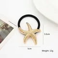Detailed view of the gold starfish metal hair tie with high-elastic black rubber band - Starfish / Gold