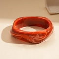 Retro red orange acrylic twisted bangle with white marble texture in a wide wave design - Orange Irregular