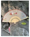Silk folding fan featuring white rabbit embroidery and pink tassels on stone - Strawberry Rabbit