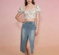 Detail of high-waist denim midi skirt with front slit and floral puff sleeve crop top - S / Light Blue