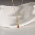 Gold necklace with LOVE pendant and red heart gemstone on white satin background - Love Red Heart
