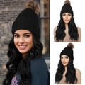 Black knitted beanie wig with a brown pompom and long black wavy synthetic hair - 1B Natural Black