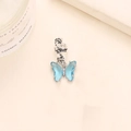 Detail of silver spiral ear cuff with a hanging transparent blue crystal butterfly pendant - Blue Crystal Silver