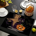 Macro detail of Halloween linen placemat featuring a black cat, pumpkin, and bat design - Style 2