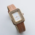 Detail of square gold watch case with double-row crystals and khaki leather strap - Pink