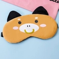 Close-up of a soft plush Shiba Inu sleep mask with elastic strap on a blue surface - Coffee Cow Style