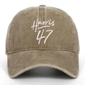 Close-up of olive green washed cotton baseball cap featuring white Harris 47 embroidery - Khaki