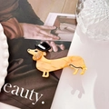 Detailed view of dachshund hair clip with acetate marbling and rhinestone accents - 8cm / Orange