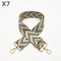 Macro detail of wide adjustable bag strap with green V-pattern and gold metal buckles - Gold Buckle / Green