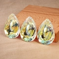 Waterdrop-shaped AB crystal pendant with multifaceted cut surface on rustic burlap background - 38MM Dragon Eye Shape / Rainbow AB