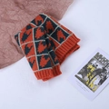 Knitted kids' scarf featuring orange and navy blue houndstooth pattern with ribbed edges - Orange Black Houndstooth