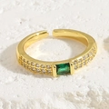 Detailed macro view of 18K gold adjustable ring with emerald-cut green zircon and pavé side stones - Emerald Rectangular Zircon