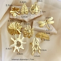 Golden stainless steel rings set with floral and geometric designs on stone base - 9-Piece Set