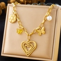 Close-up of gold layered necklace with ceramic floral heart and butterfly charms - Heart Sunflower Butterfly Pearl (N3172)