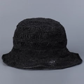 Close-up view of a chic handmade black hollow woven straw bucket hat for women - M / Black
