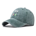 Macro view showing vintage washed cotton fabric and high-quality embroidery on baseball cap - Adjustable / Jesus Green