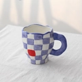 Handmade ceramic coffee mug featuring blue and white grid pattern with a bold red square accent - Purple Checkerboard Cup