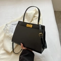 Elegant black leather trapezoid handbag with gold buckle and top handle for women - Black