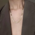 Macro detail of high-polish gold herringbone snake chain necklace on model neck - 4mm Single Gold 50+5cm
