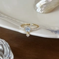 Adjustable S925 silver ring in gold with white pearls and a light blue flower charm - Pearl Blue Flower Pendant (J6154)