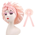 Detailed view of pink satin sleep bonnet with adjustable ribbon bow on model - Cross-Cherry Pink