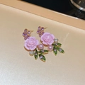 Detailed view of pink rose earrings with purple flowers and pearls on a beige tray - Stud Earrings (925 Silver Pin) / Purple Flower Leaf Stud Earrings