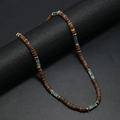 Detail of bohemian necklace with brown coconut beads and green natural stones - Mint Green