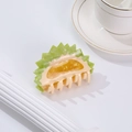 Unique durian-shaped hair claw clip in green and yellow resin on white background - Durian
