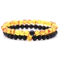 Close-up of 6mm amber and matte black beaded couple distance bracelets with elastic cord - Amber