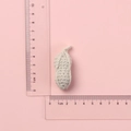 Handmade beige crochet fruit pendant measurement with a clear ruler on pink background - Off-White Peanut Doll