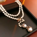 Detail view of pearl necklace with gold bird clasp and two large dangling pearls - 96# Necklace Rhinestone Pearl Flower Bird