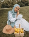 Elegant solid light blue pearl chiffon hijab scarf wrap shown on a model in sunlight - Light Blue