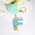 Letter F keychain with blue stones, gold flakes and mint green pompom for bags - Letter F