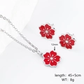 Dettaglio set gioielli fiore rosso con collana 45+5cm e orecchini a fiore da 12mm - Set Fiore di Ciliegio Rosso Colore Acciaio / Argento/Rosso