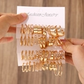 Fashionable gold hoop earrings set with pearls displayed on jewelry card - 27 KC Gold