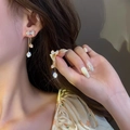 Elegant gold bow earrings with three-layer rhinestone tassels on model's ear - 925 Silver Needle / Bowknot Tassel Earrings