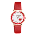 Close-up of a women's watch featuring a red heart motif on a white dial with gold accents - Red