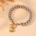 Silver bead bracelet with gold heart pendant and toggle clasp on warm background - Steel Beads Heart OT Buckle Style (I501) / Silver/Gold