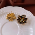 Detailed view of flower earrings with black enamel and rhinestones on a white plate - Black Base Yellow Zirconia Flower Vintage Earrings (27#)
