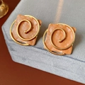 Detailed macro view of vintage square enamel earrings with gold spiral accents on suede - 925 Silver Needle / Brown