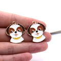 Macro shot of two cute cartoon dog charms with enamel finish and gold edges - Beagle Dog