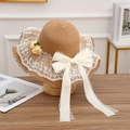 Light brown straw sun hat with white lace trim, large bow and yellow floral detail - Side Flower Khaki