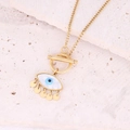 Golden evil eye necklace with mother of pearl inlay and five dangling charms on a stone background - Eye Pendant Gold Disc T-Bar Necklace (5#)